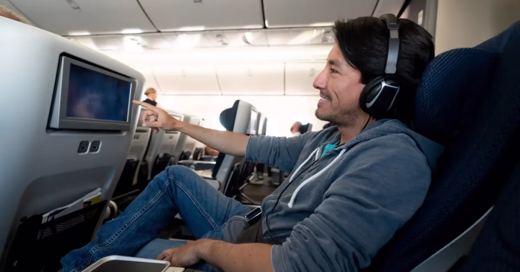 raveler enjoying podcasts and travel videos on airplane.