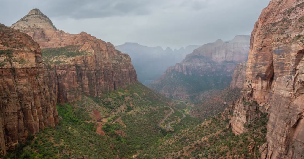 Panoramic view from Mount Snowdon showing hiker and surrounding mountains