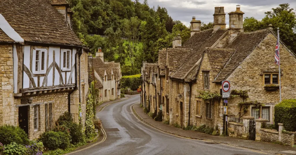 Scenic Cotswolds village with honey-colored cottages and a riverside path.