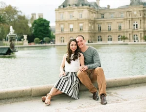 Couple sitting by a fountain in Luxembourg Gardens.