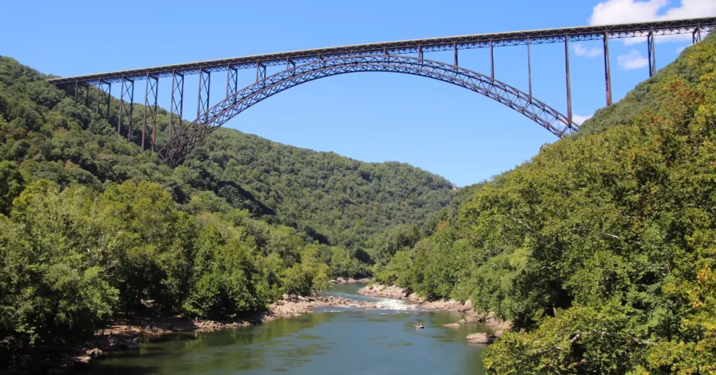 Traveler crossing vine bridge over Iya Valley river in Shikoku Adventure Travel in Japan
