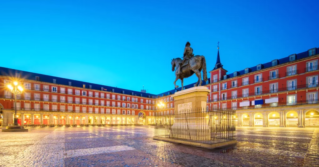 Evening view of Plaza Mayor in Madrid, main attraction in Spain travel guide.