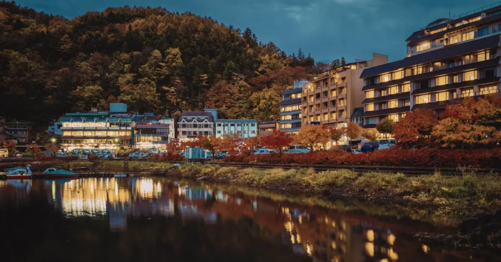 Seine River glowing under city lights in Paris at night with reflections on the water.