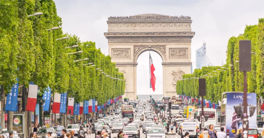 Travellers walking safely in a well-lit Paris street at night.