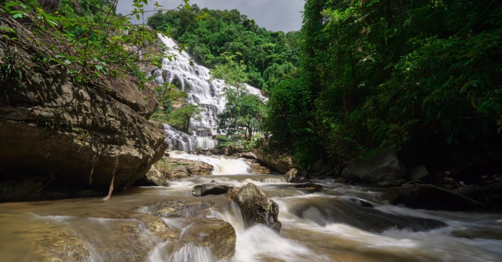 Small hidden waterfall in Flores highlands with clear water and jungle surroundings