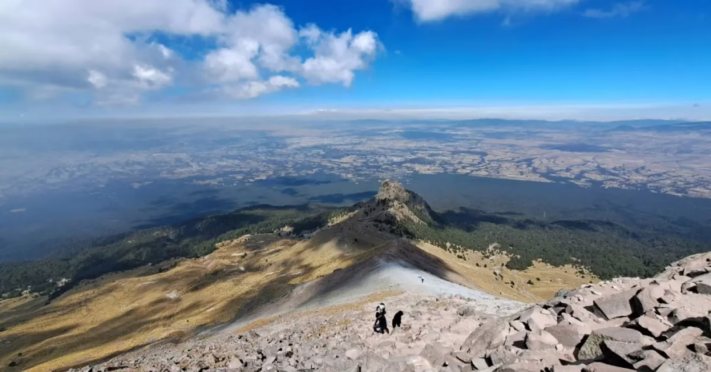 Steep rocky section near Trunyan Hill summit with a hiker navigating carefully